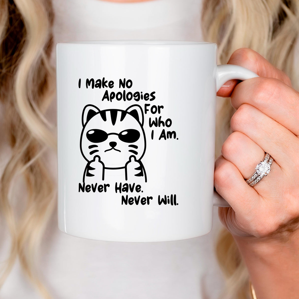 White ceramic coffee mug with cat graphic and 'Never Have, Never Will' quote