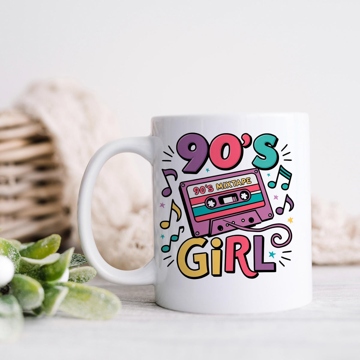 White ceramic mug with 90's Girl cassette tape graphic and bold “90's” text