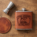 Engraved stainless steel hip flask with open cap, tan leather and trout graphic