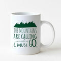 White ceramic coffee mug with green mountain graphic and text design on front