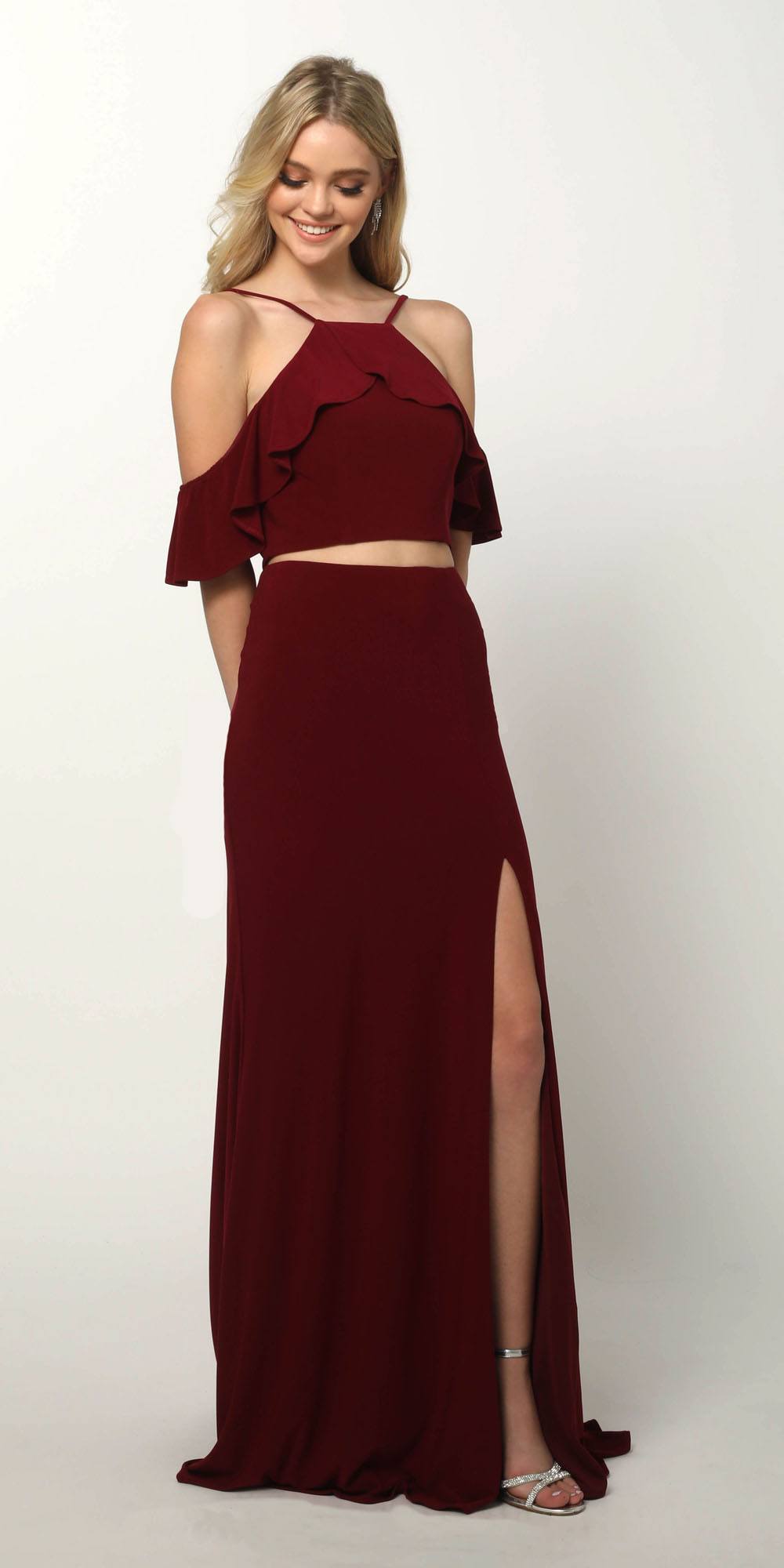 Burgundy cold-shoulder two-piece gown with ruffled cropped top and high-hem slit skirt