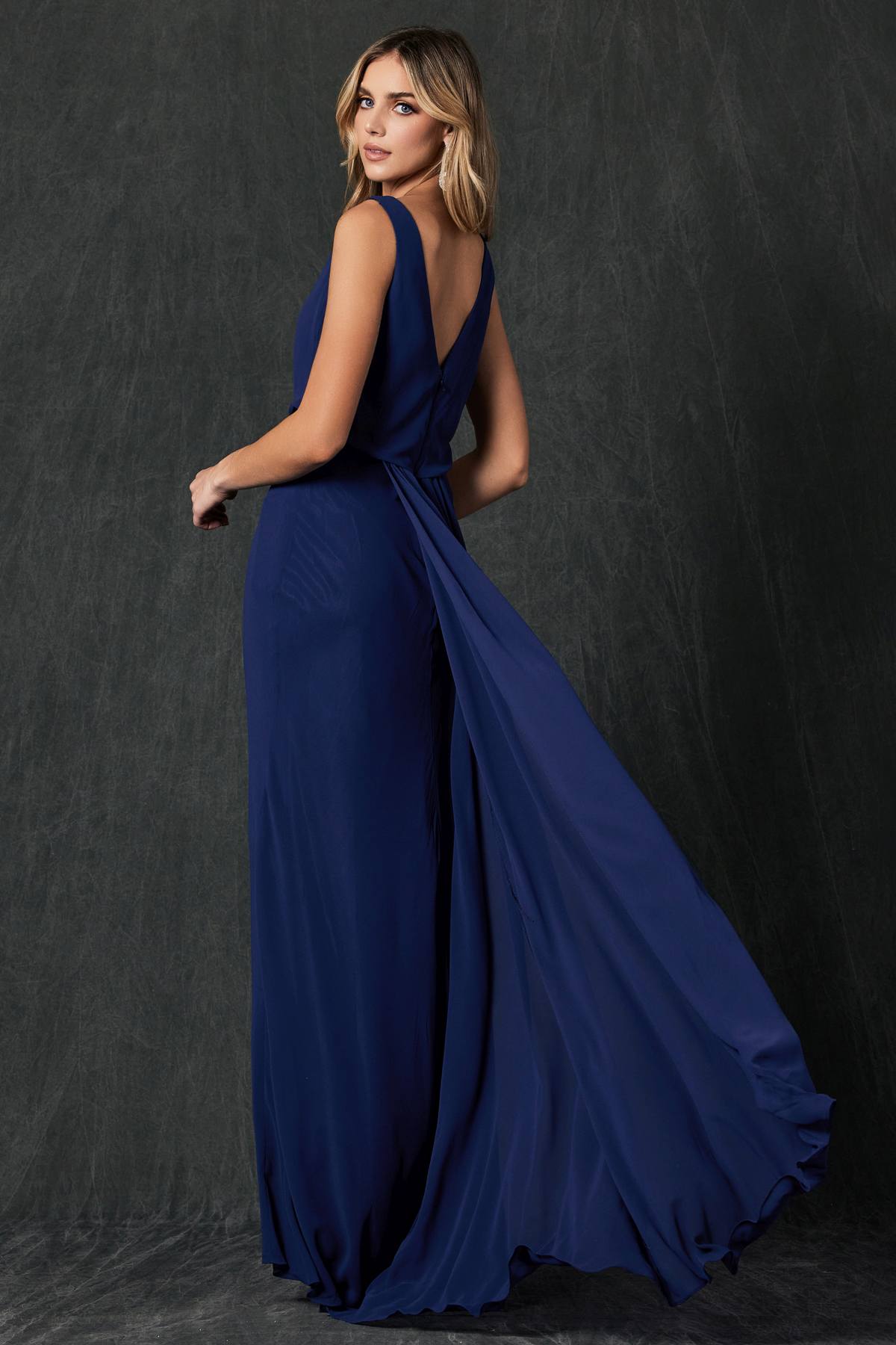 Navy floor-length formal dress with sleeveless cowl neck and side drape
