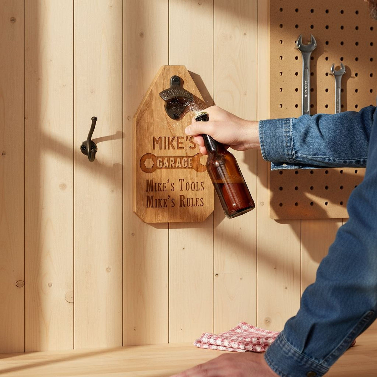 Personalized wood garage sign with bottle opener mounted on light wood wall