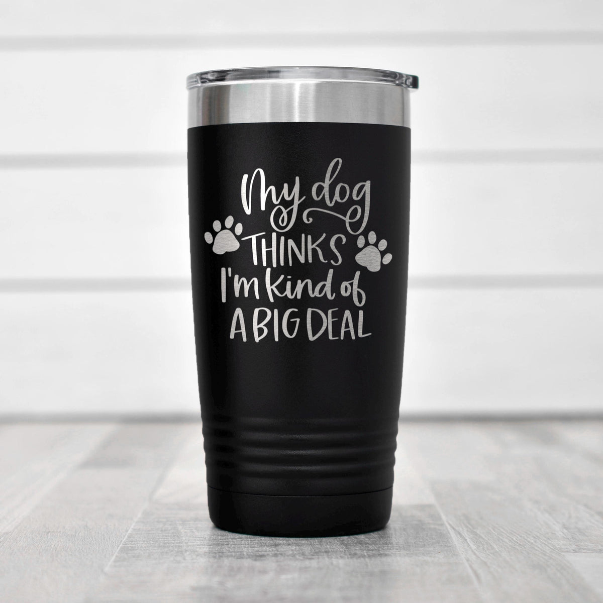 Black stainless steel travel tumbler with dog paw quote: “My dog thinks I’m kind of a big deal”.