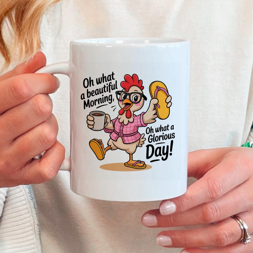 White ceramic mug held in hands, showing colorful chicken graphic and printed message