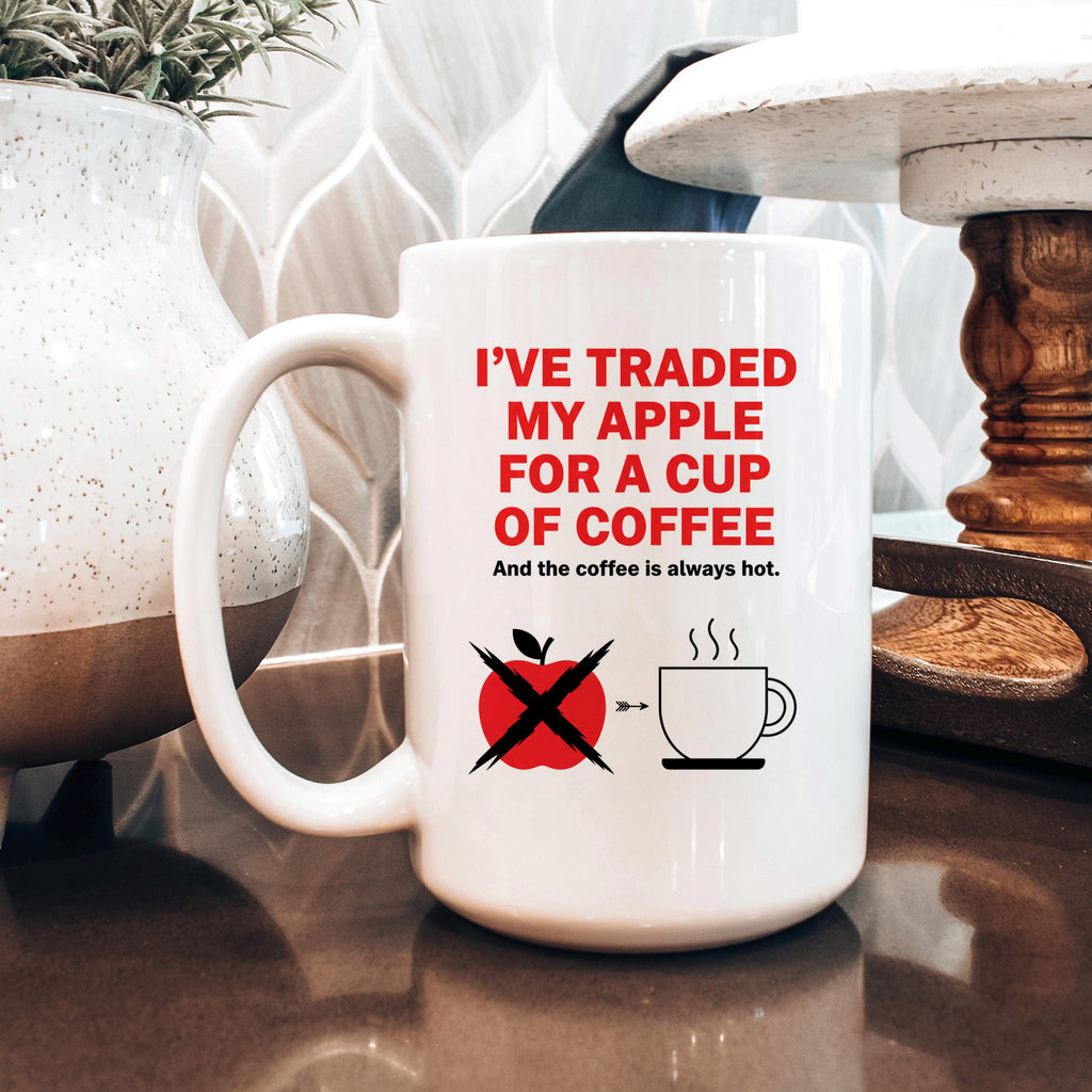 White ceramic mug with red and black 'I've traded my apple for a cup of coffee' design