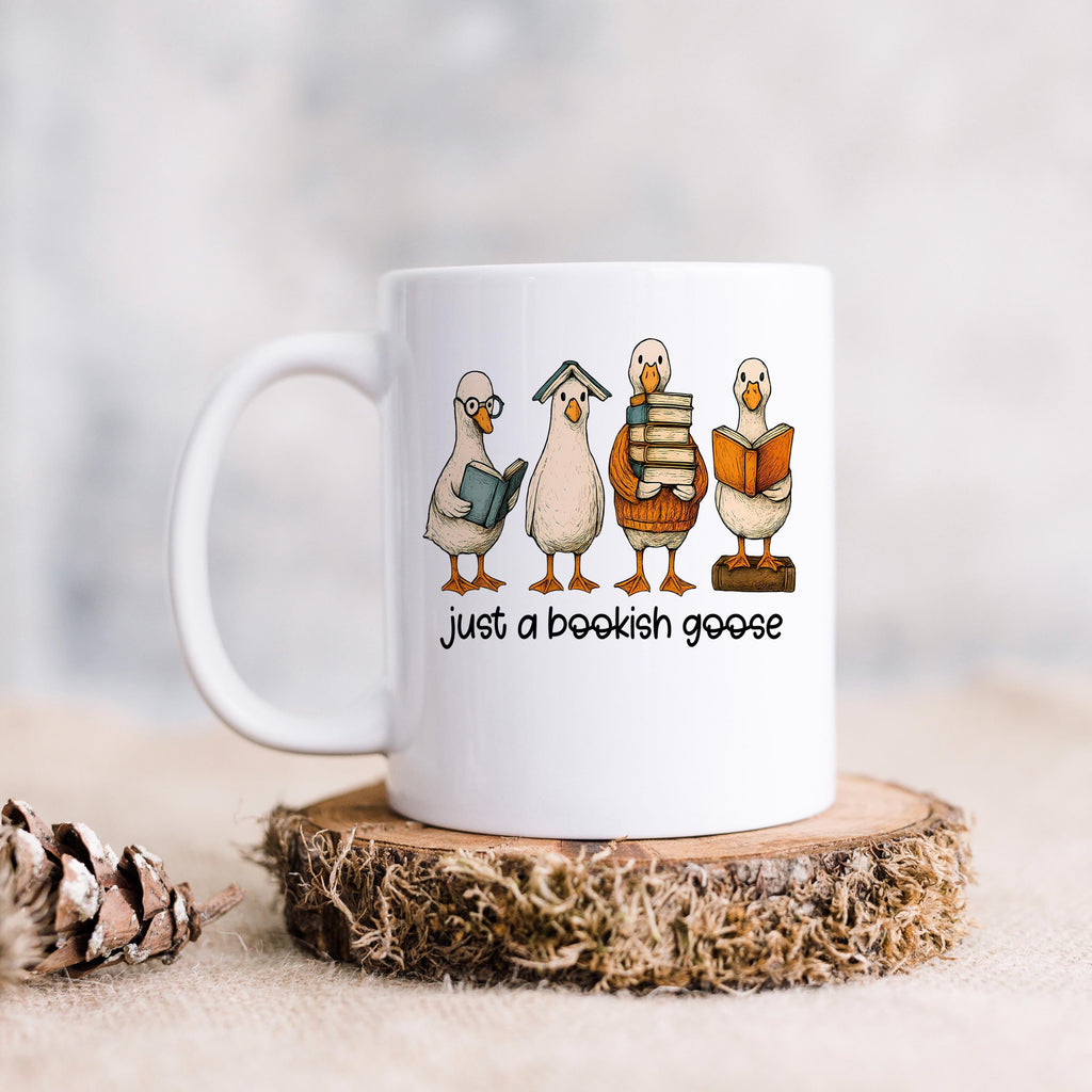 White coffee mug with bookish goose illustration and "just a bookish goose" phrase