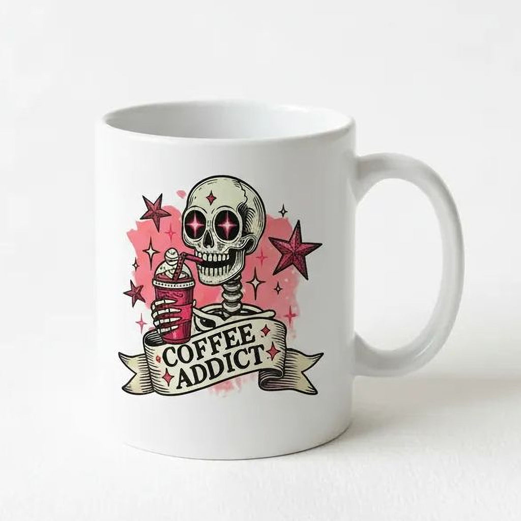 White ceramic coffee mug with pink skull 'Coffee Addict' design, side view with handle