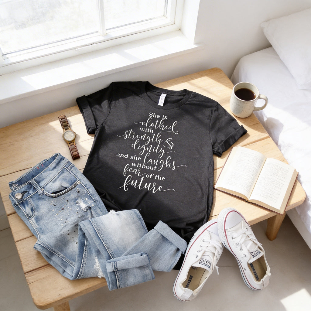 Black women's graphic T-shirt with "She is clothed..." verse print on front.
