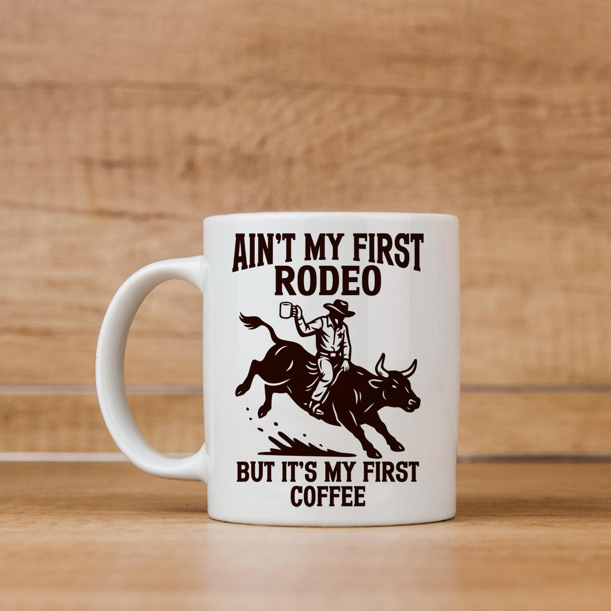 White ceramic coffee mug with cowboy rodeo quote and illustrated bull rider.