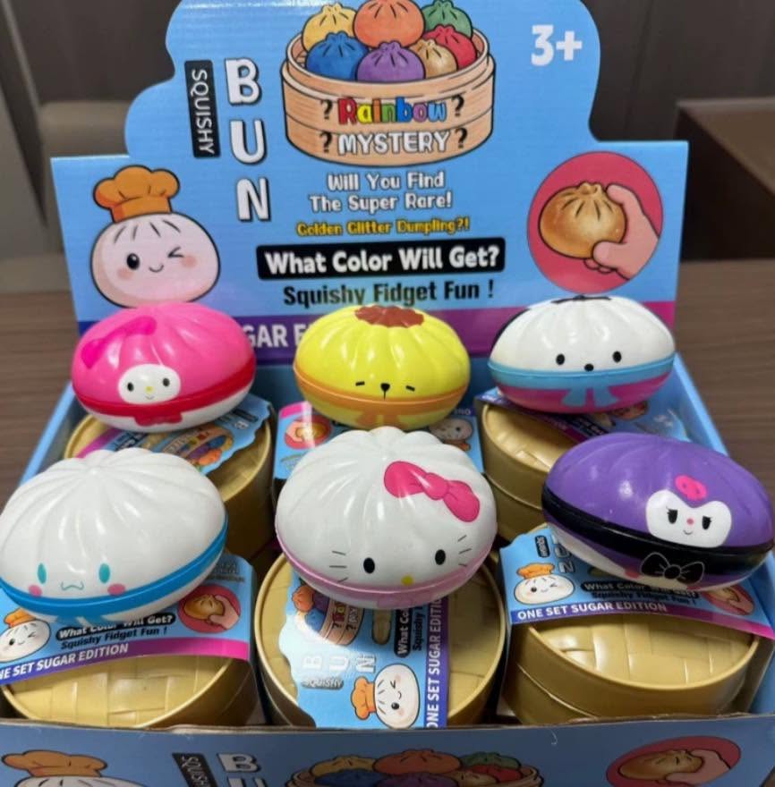 Assorted round character dumpling steamer squishy fidget toys in a display box, bright mix