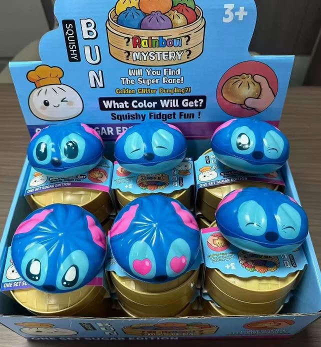 Assorted blue and pink character dumpling steamer squishy fidget toys in a display box