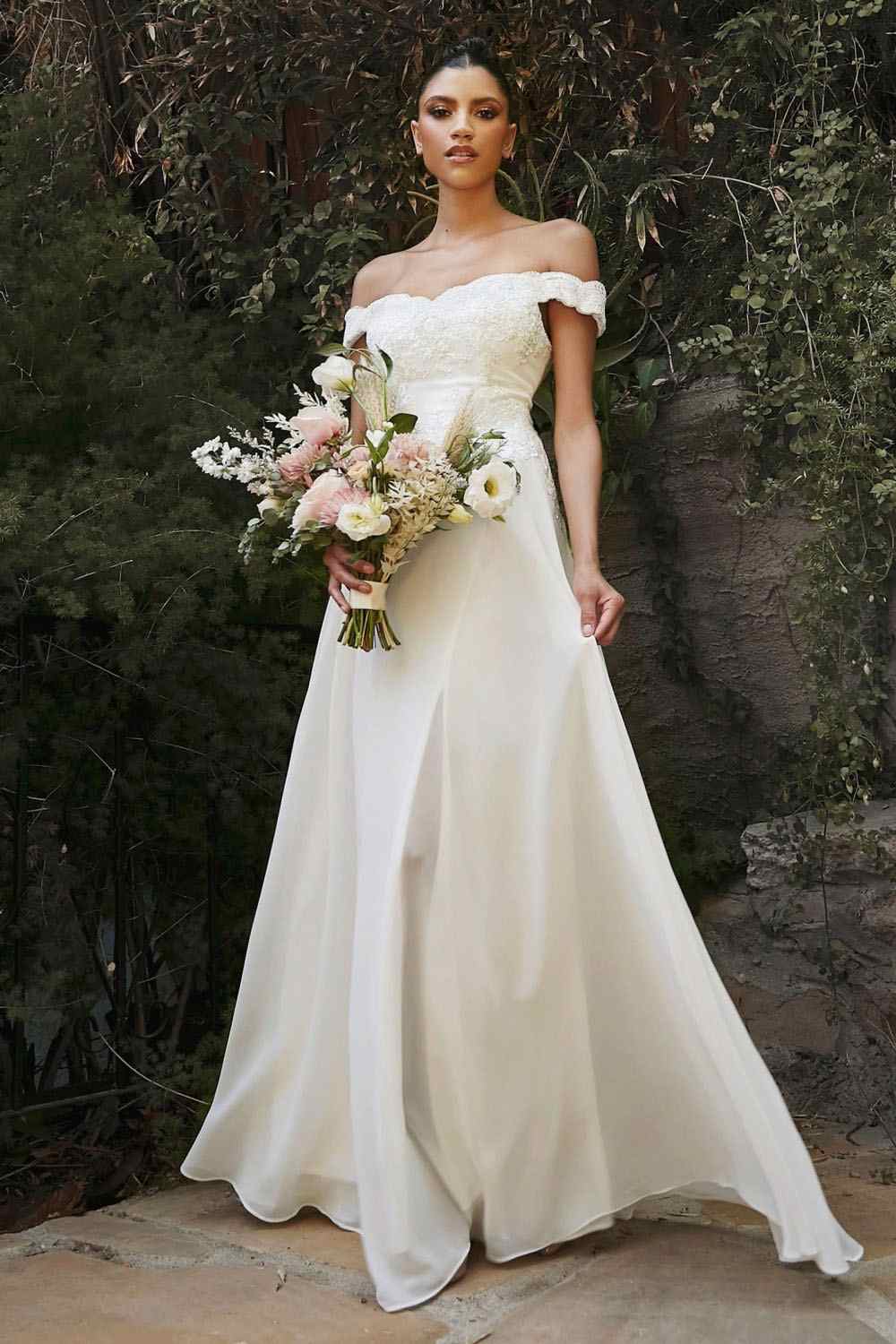 Off-shoulder off-white lace long gown with floral bouquet and flared skirt