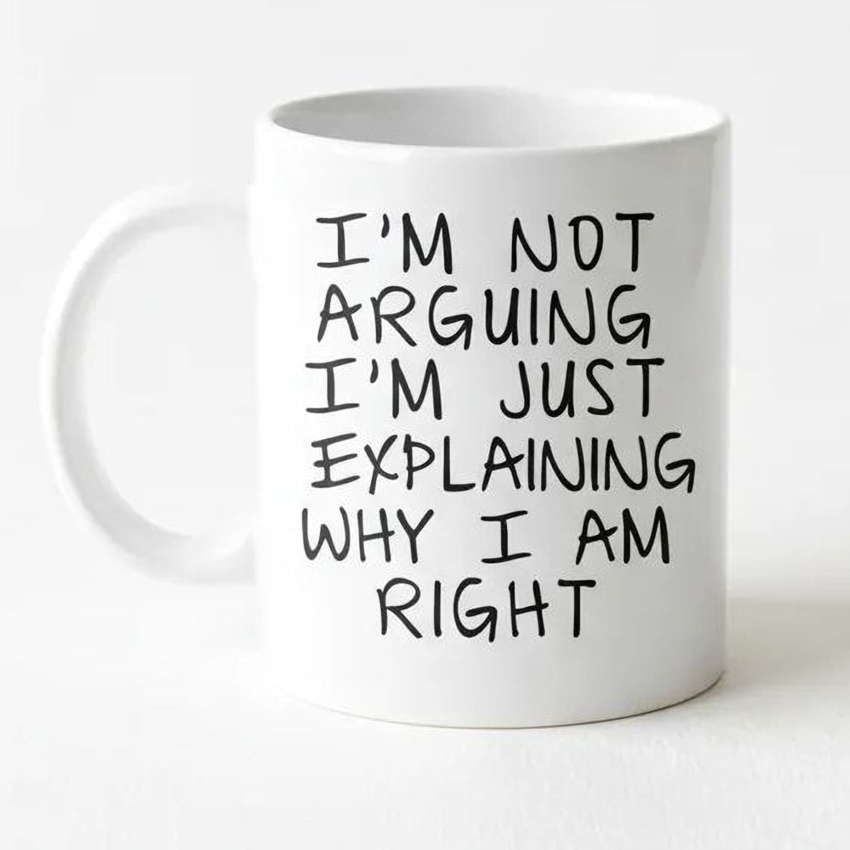 White ceramic coffee mug with black “I’m not arguing…” text