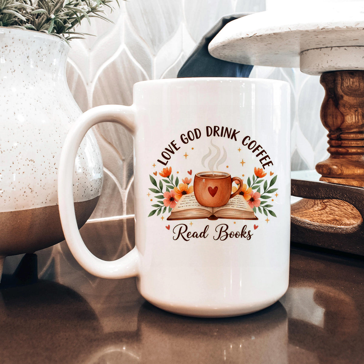 White coffee mug with floral wreath, heart coffee cup, and 'Read Books' text
