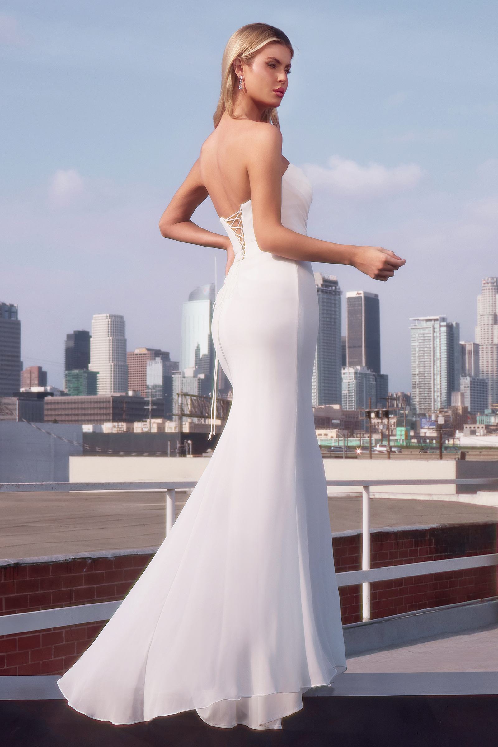 Off-white strapless fitted chiffon dress side view with draped waist and flared skirt