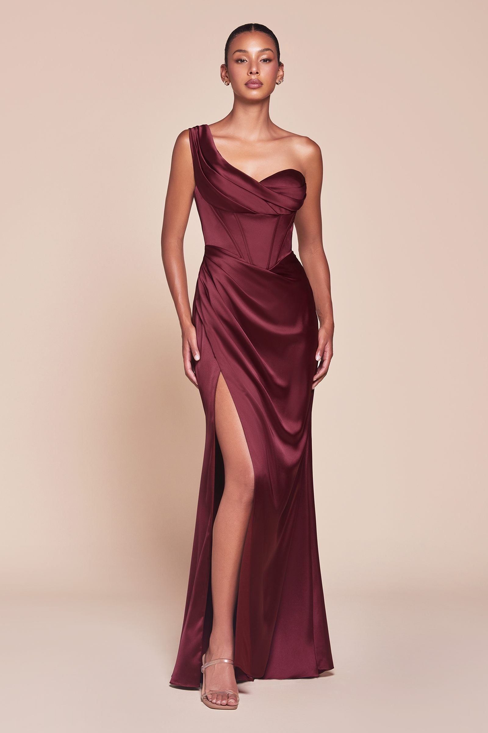 Burgundy satin corset gown with one-shoulder neckline and thigh-high slit