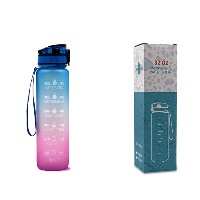 Pink-to-purple gradient bottle with blue lid and wrist strap, next to “32 OZ” box