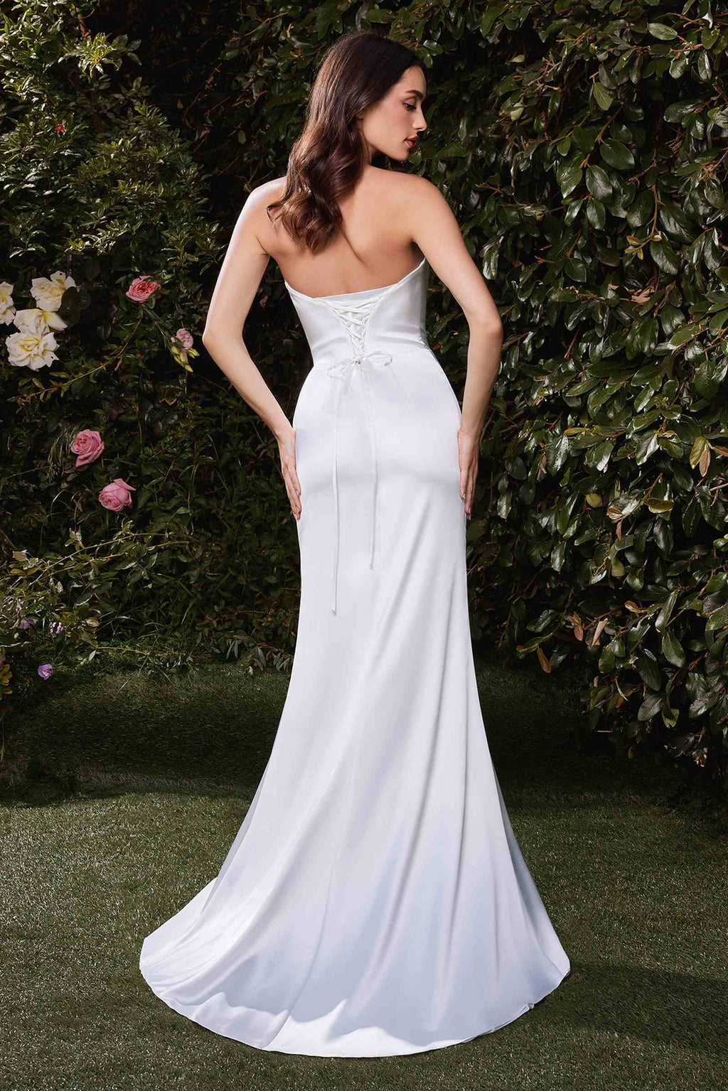 Off-white satin bridal gown with thin straps, fitted waist and flowing skirt