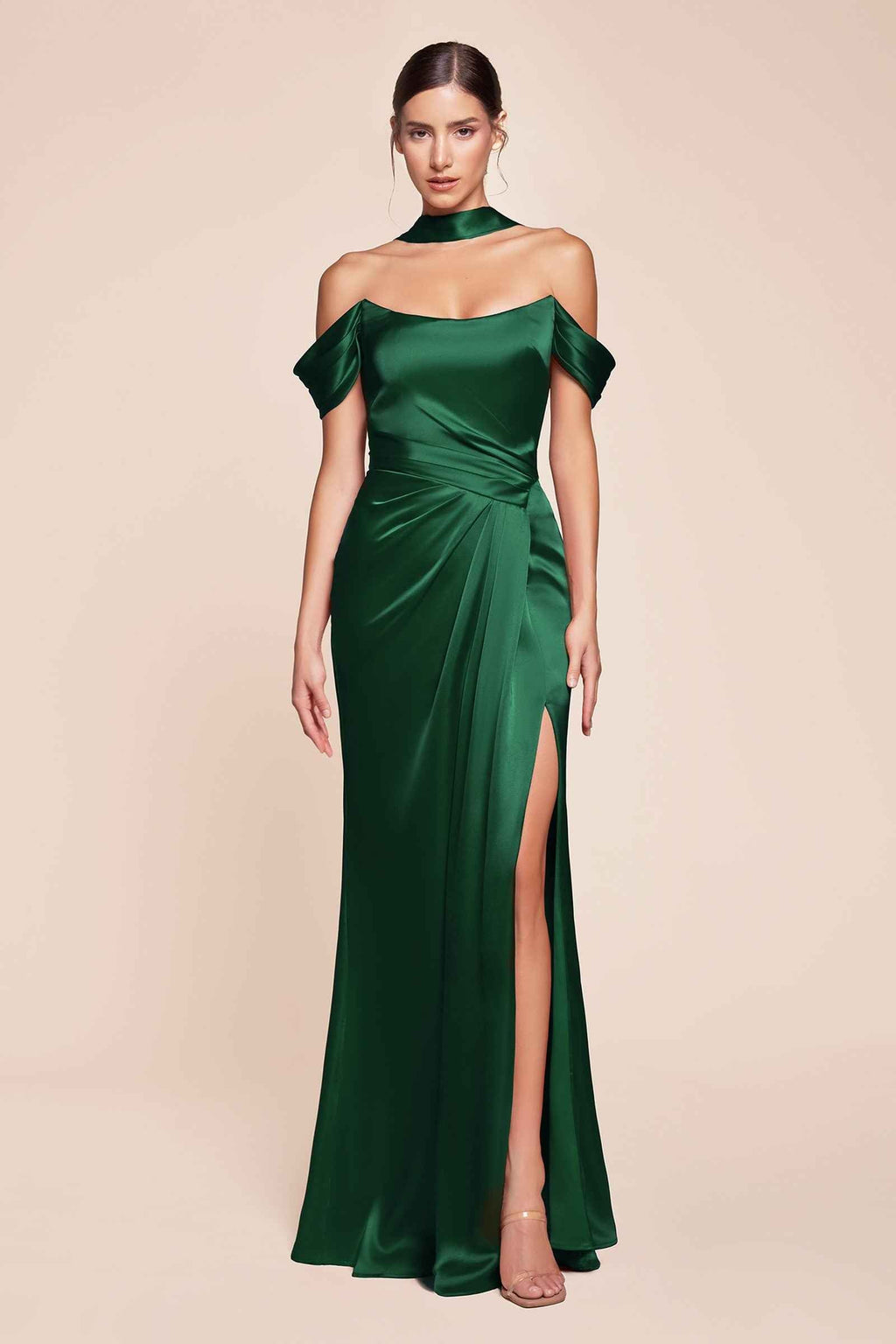 Off-shoulder green satin gown with ruched waist and front slit, full length.