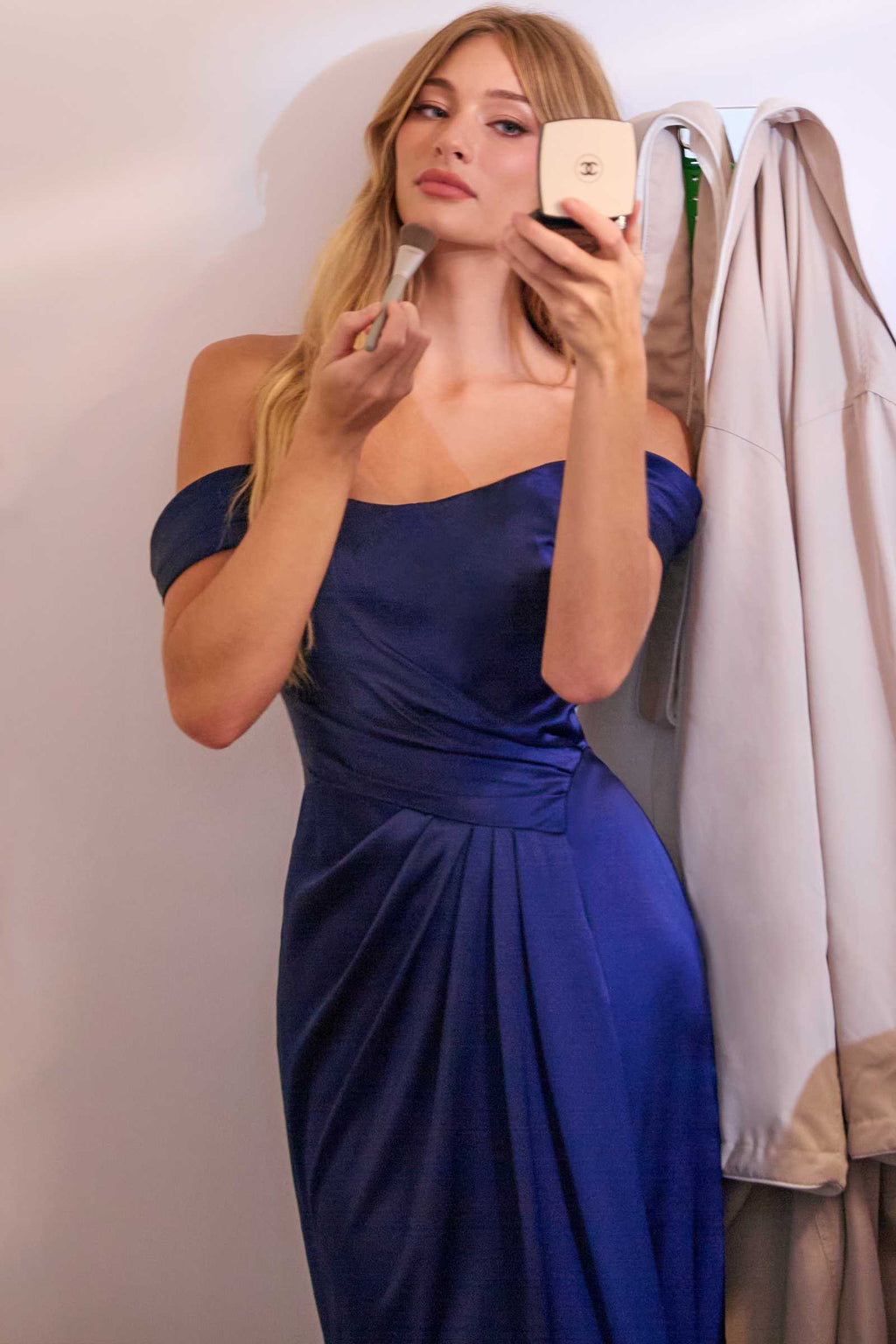 Navy off-shoulder satin gown with ruched corset bodice and draped skirt
