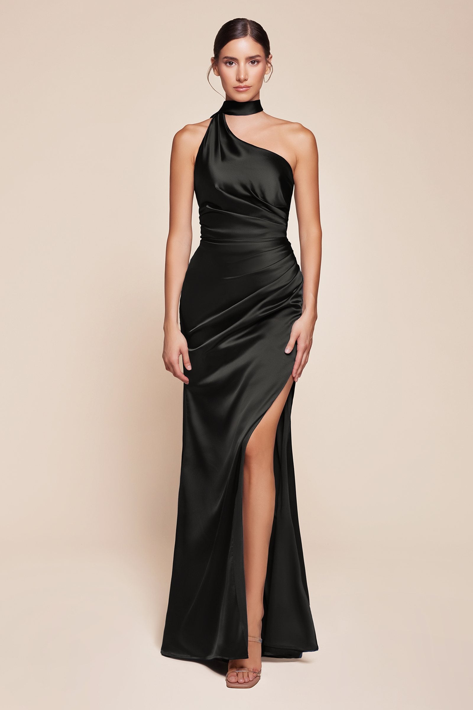 One-shoulder fitted satin gown with side slit, black glossy finish.