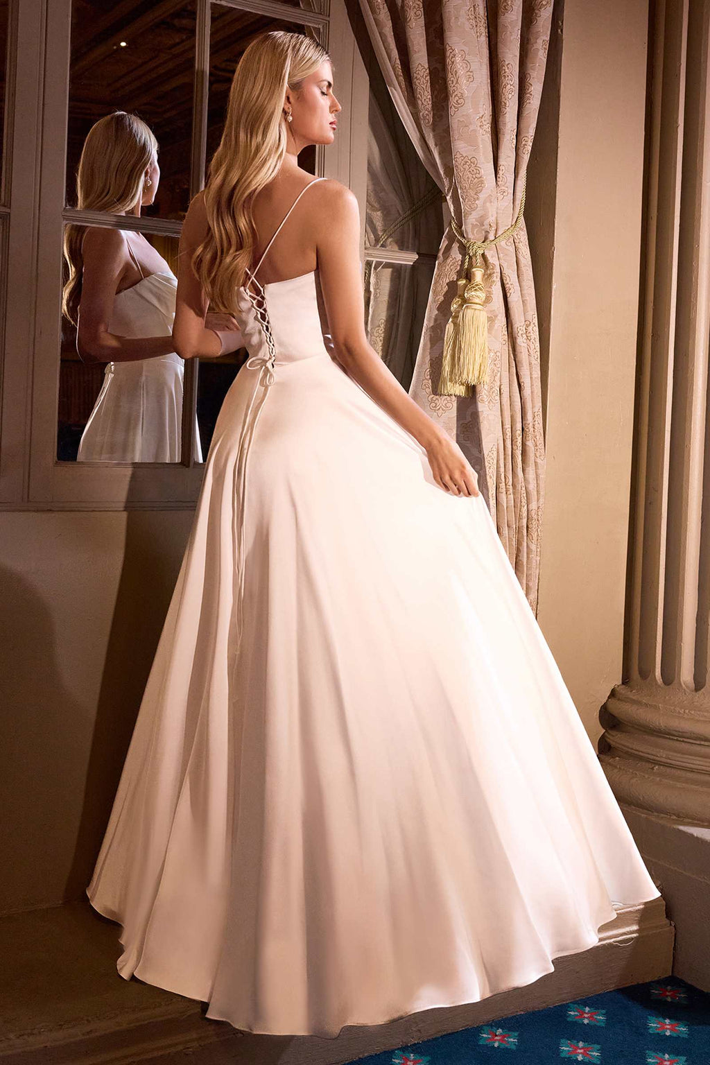 Off-white A-line bridal gown with pleated sweetheart bodice and flowing skirt