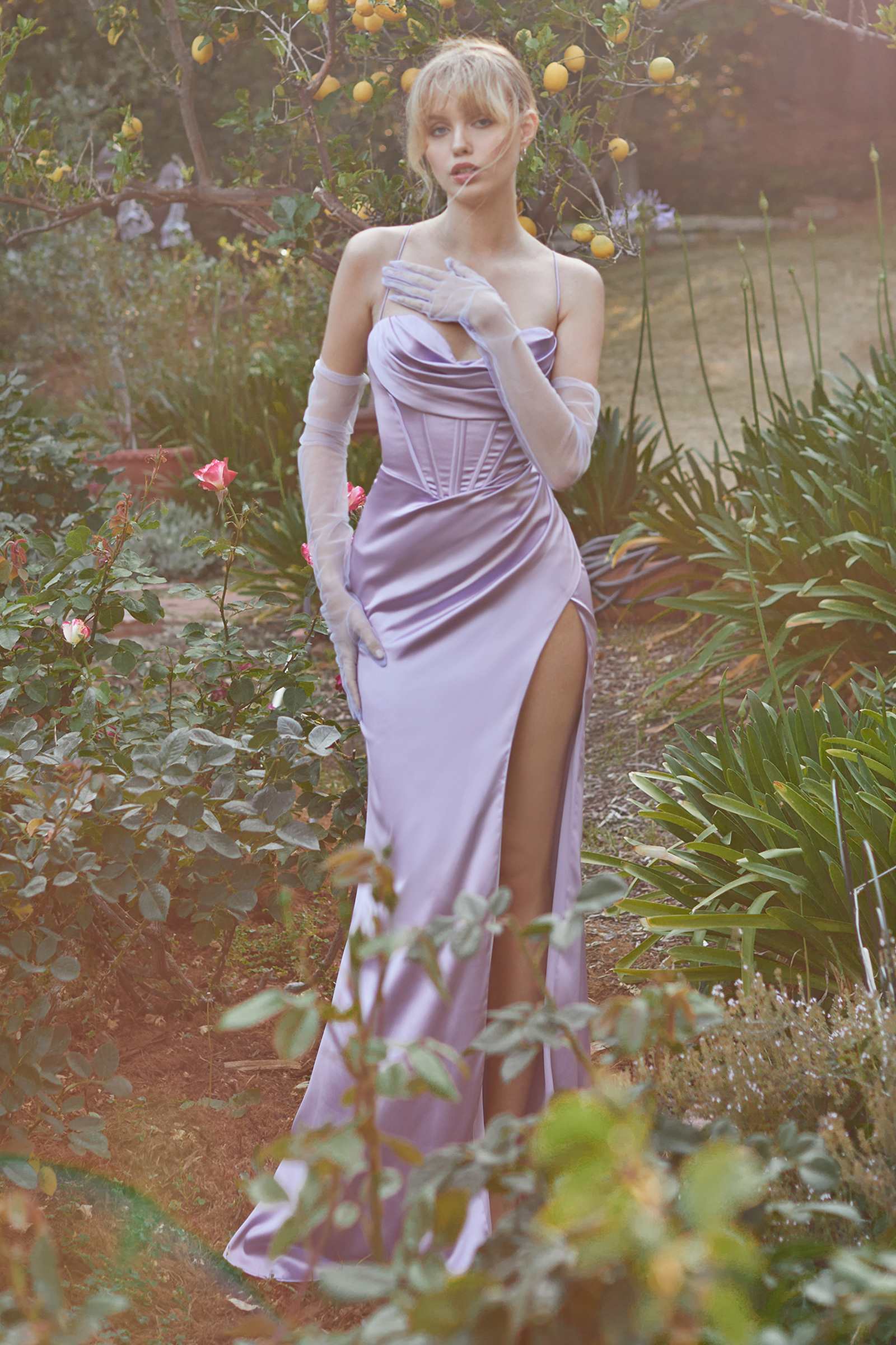 Light pink satin formal corset gown with cowl neckline, spaghetti straps, and side slit