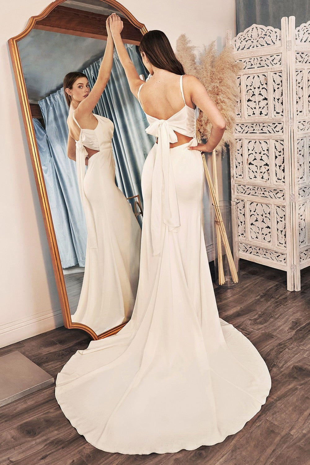 Off-white satin backless dress with tied bow and flowing mermaid skirt