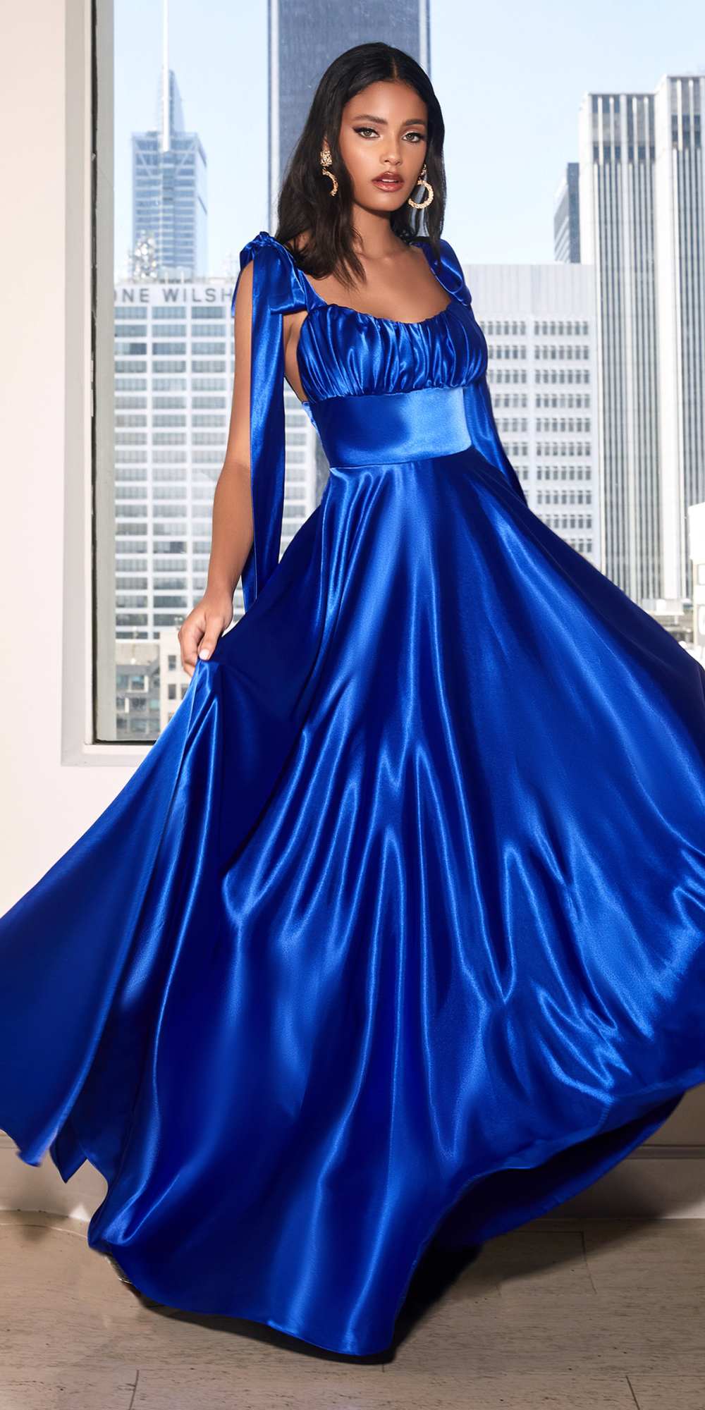 Blue satin long dress with gathered bodice, square neckline, and full flowing skirt