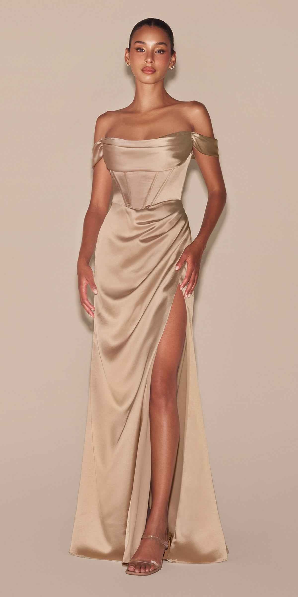 Off-shoulder satin corset gown in champagne beige with draped neckline and thigh-high slit