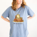 Blue T-shirt with sleeping frog graphic and text “We nap at noon.”