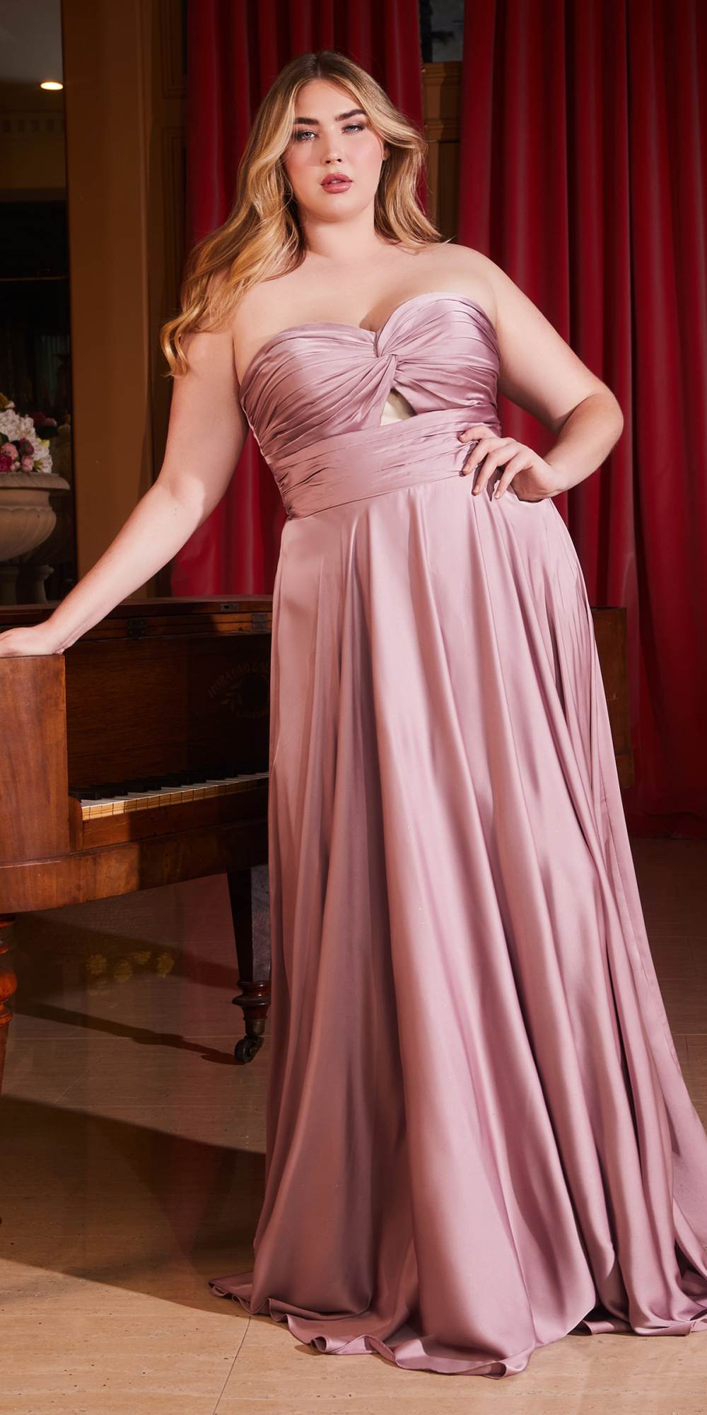Floor-length satin strapless A-line dress in dusty mauve with ruched knot bodice.