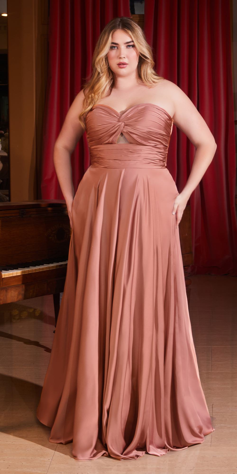 Floor-length satin strapless A-line dress in rose-brown with ruched knot bodice detail.