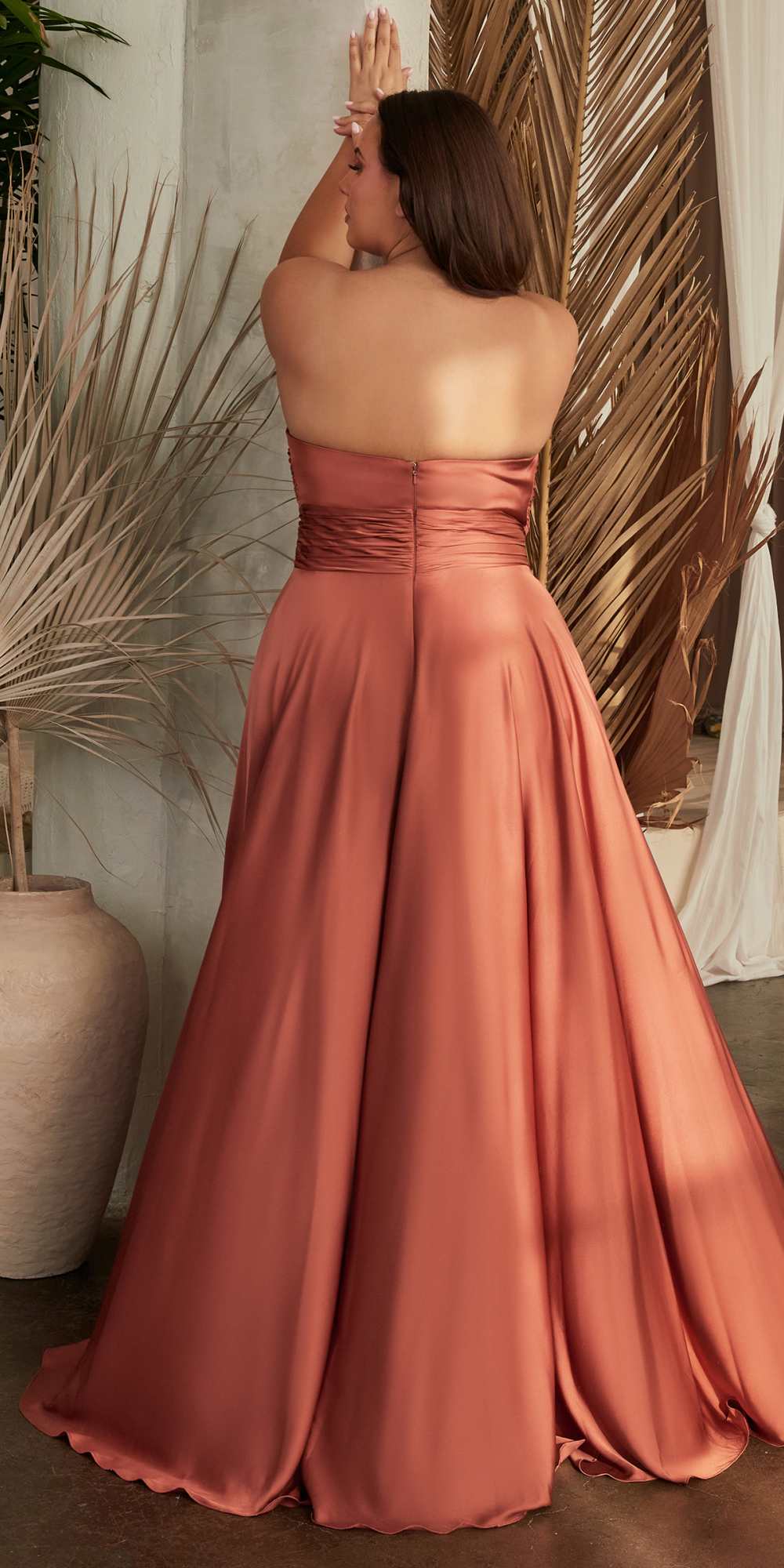 Floor-length satin strapless A-line dress in rose-brown with ruched knot bodice detail.