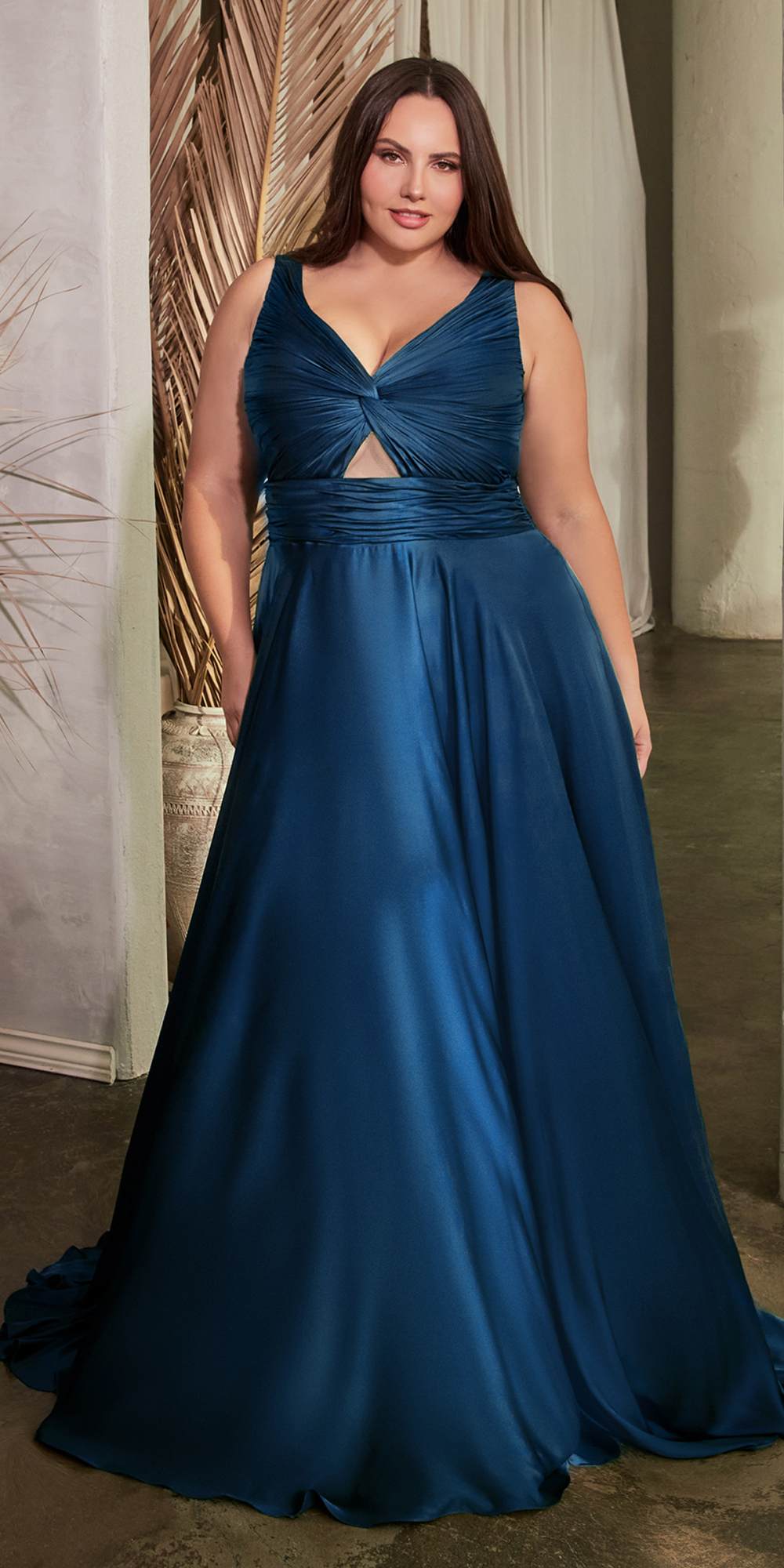 Formal satin A-line gown in dark teal-blue, twisted bodice with keyhole, sleeveless.
