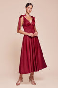 Satin A-line tea-length dress in deep burgundy with V-neck and tie shoulder detail