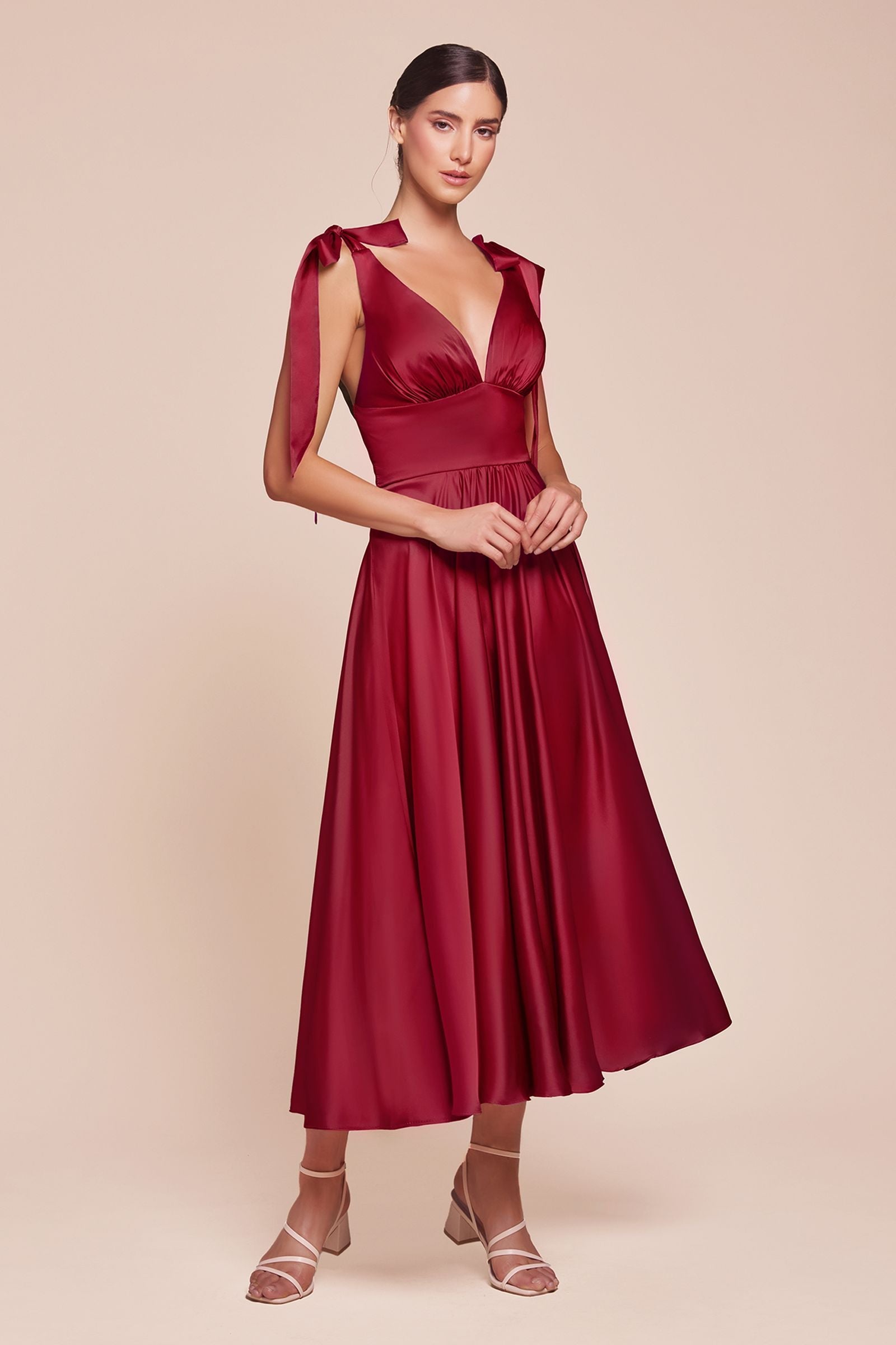 Satin A-line tea-length dress in deep burgundy with V-neck and tie shoulder detail