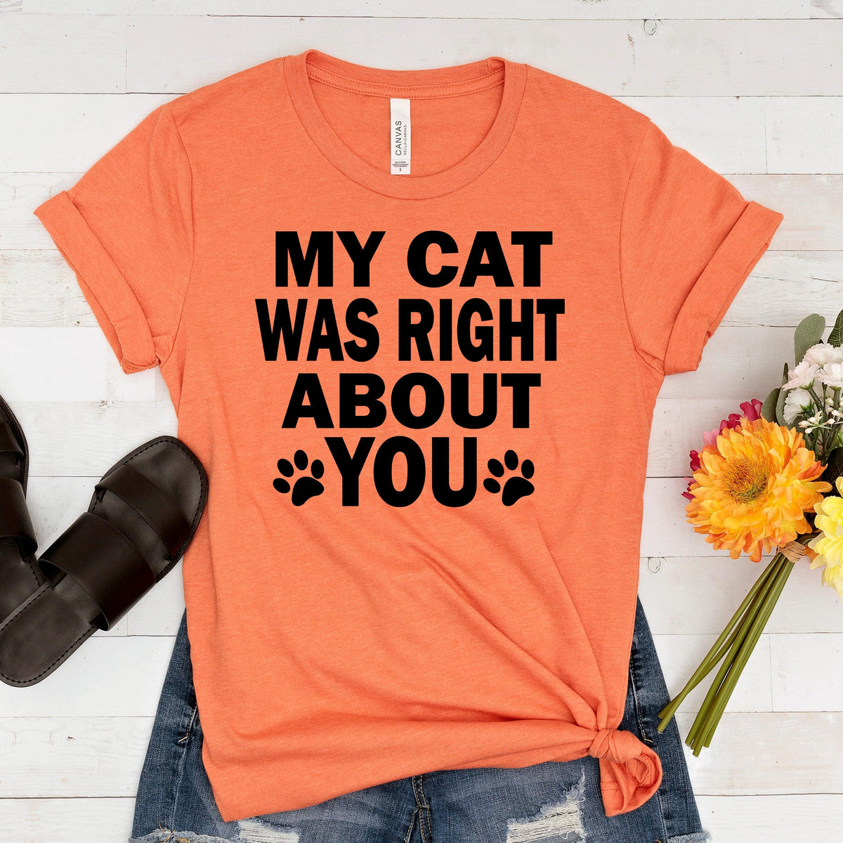 Orange graphic cat slogan t-shirt with 'MY CAT WAS RIGHT ABOUT YOU' paw print