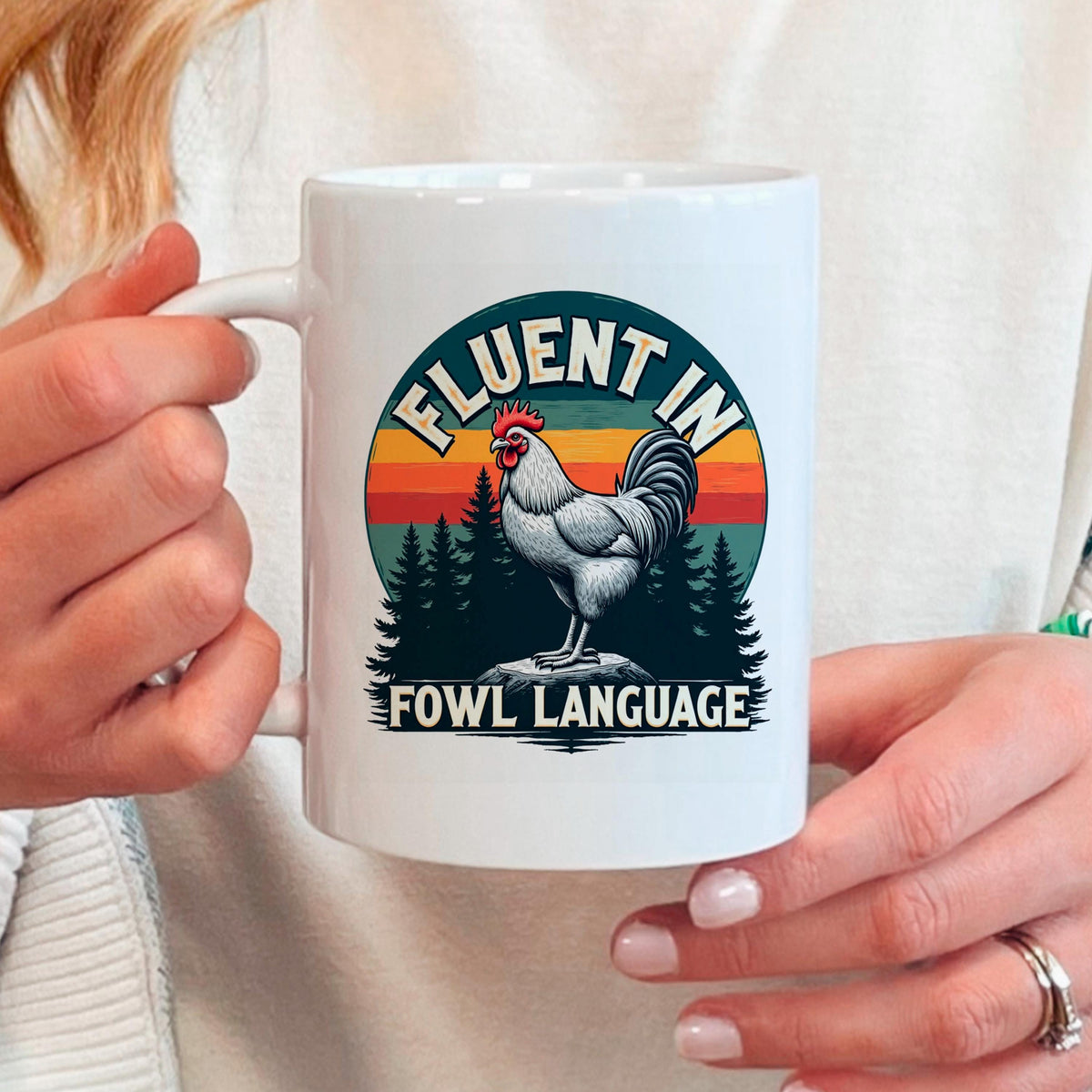 White ceramic coffee mug with rooster graphic and 'Fowl Language' lettering