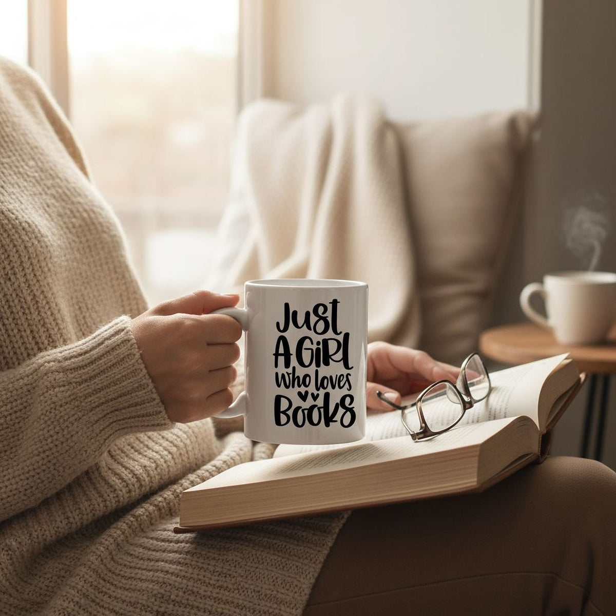 White ceramic coffee mug on table with "Just A Girl who loves Books" print