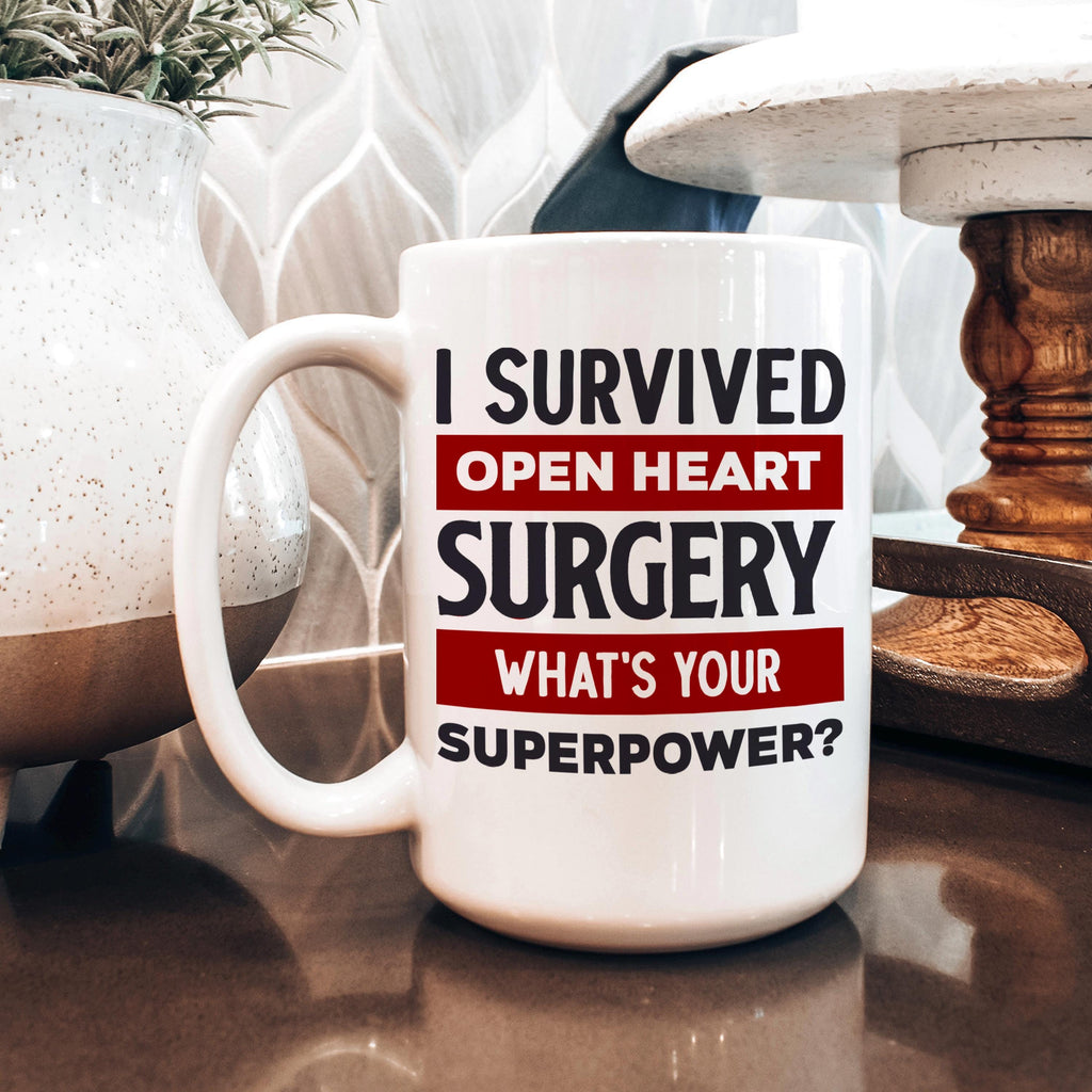 White coffee mug with bold text: I Survived Open Heart Surgery, What’s Your Superpower?