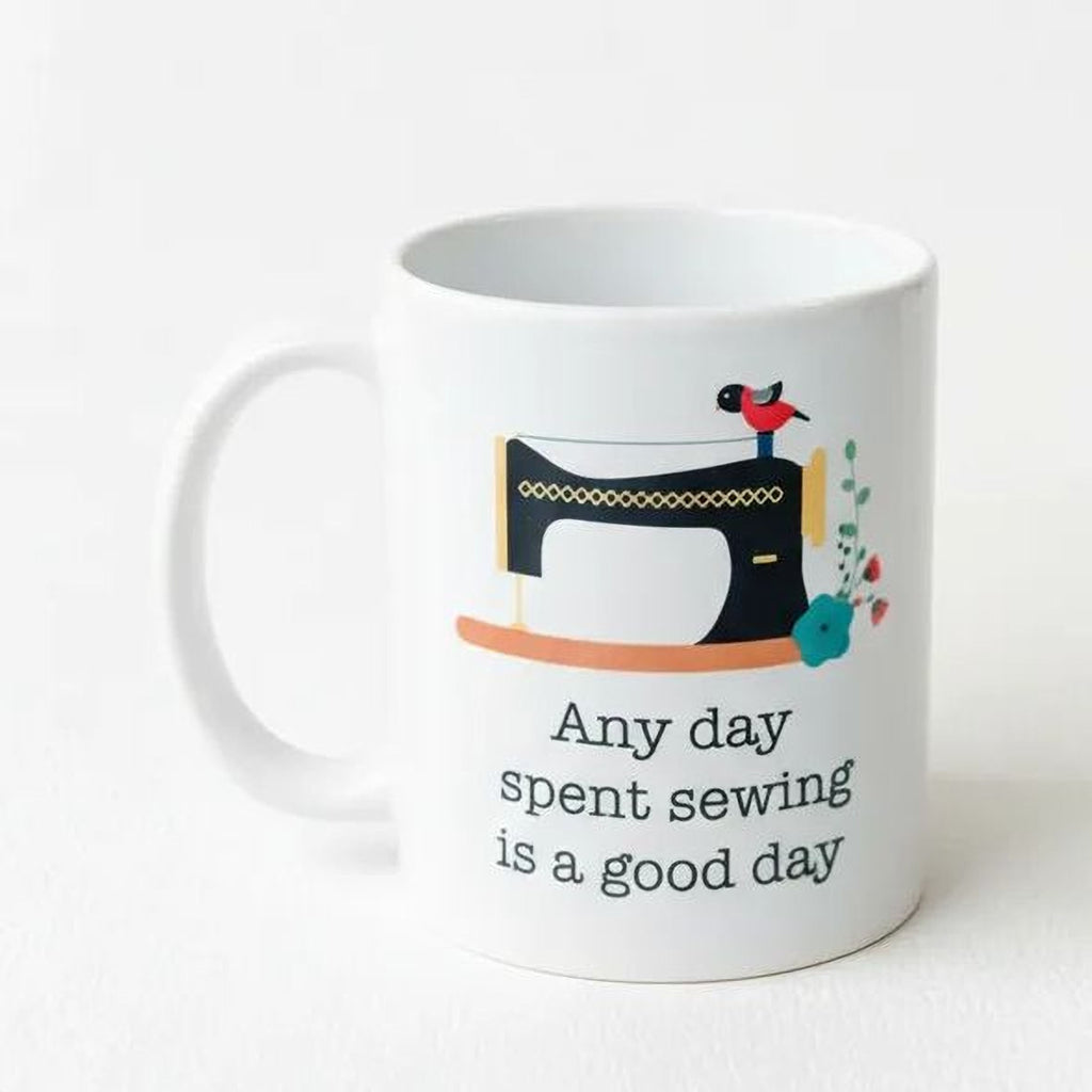 White coffee mug with sewing machine graphic and "Any day spent sewing is a good day"