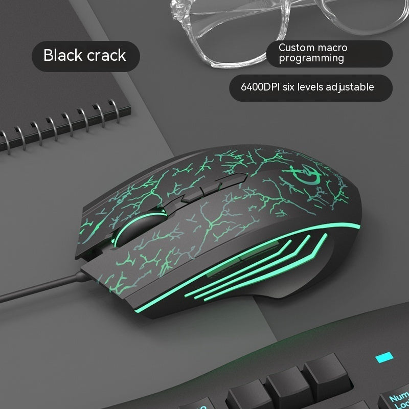 Wired esports gaming mouse in black with green crack pattern and green glowing light bars.
