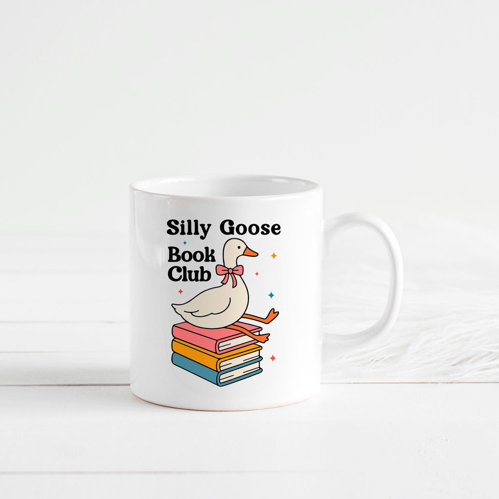 White ceramic mug with centered goose-and-books illustration and 'Silly Goose Book Club' text.