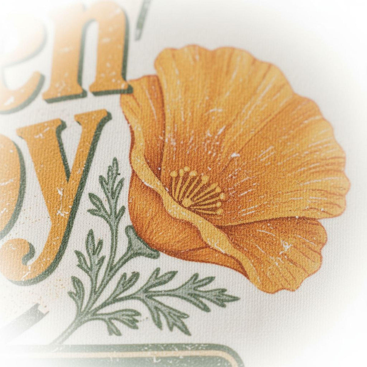 Ivory T-shirt close-up of orange California poppy flower graphic with green leaves