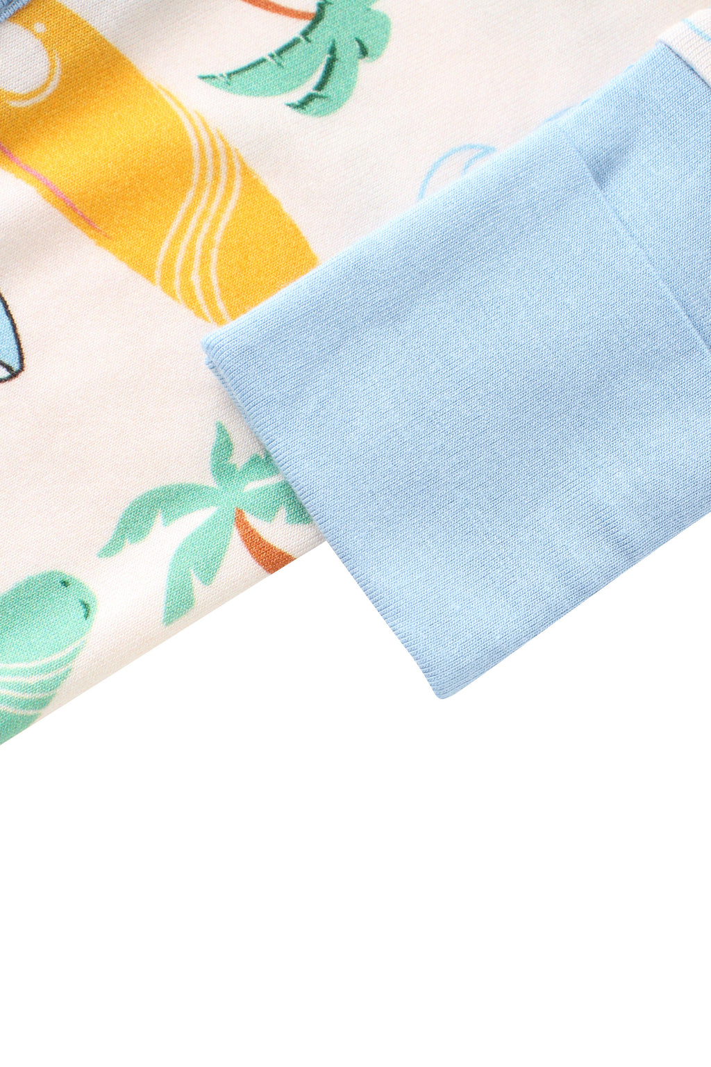 Baby romper sleeve cuff in light blue on cream fabric with surfboard print