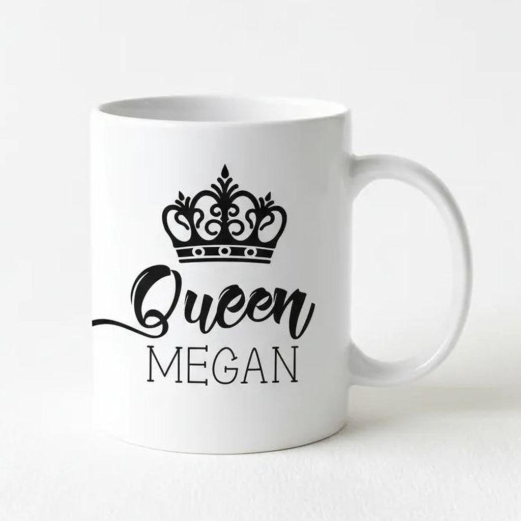 White ceramic coffee mug with black crown icon and “Queen” name print, right-side handle.