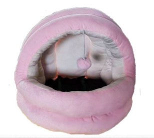 Pink cat cave bed with rounded tunnel opening and plush lining, pet sleeping in the nest