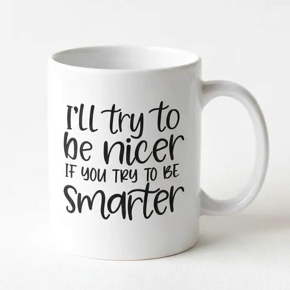 White ceramic coffee mug with black quote: 'I'll try to be nicer; if you try to be smarter'.